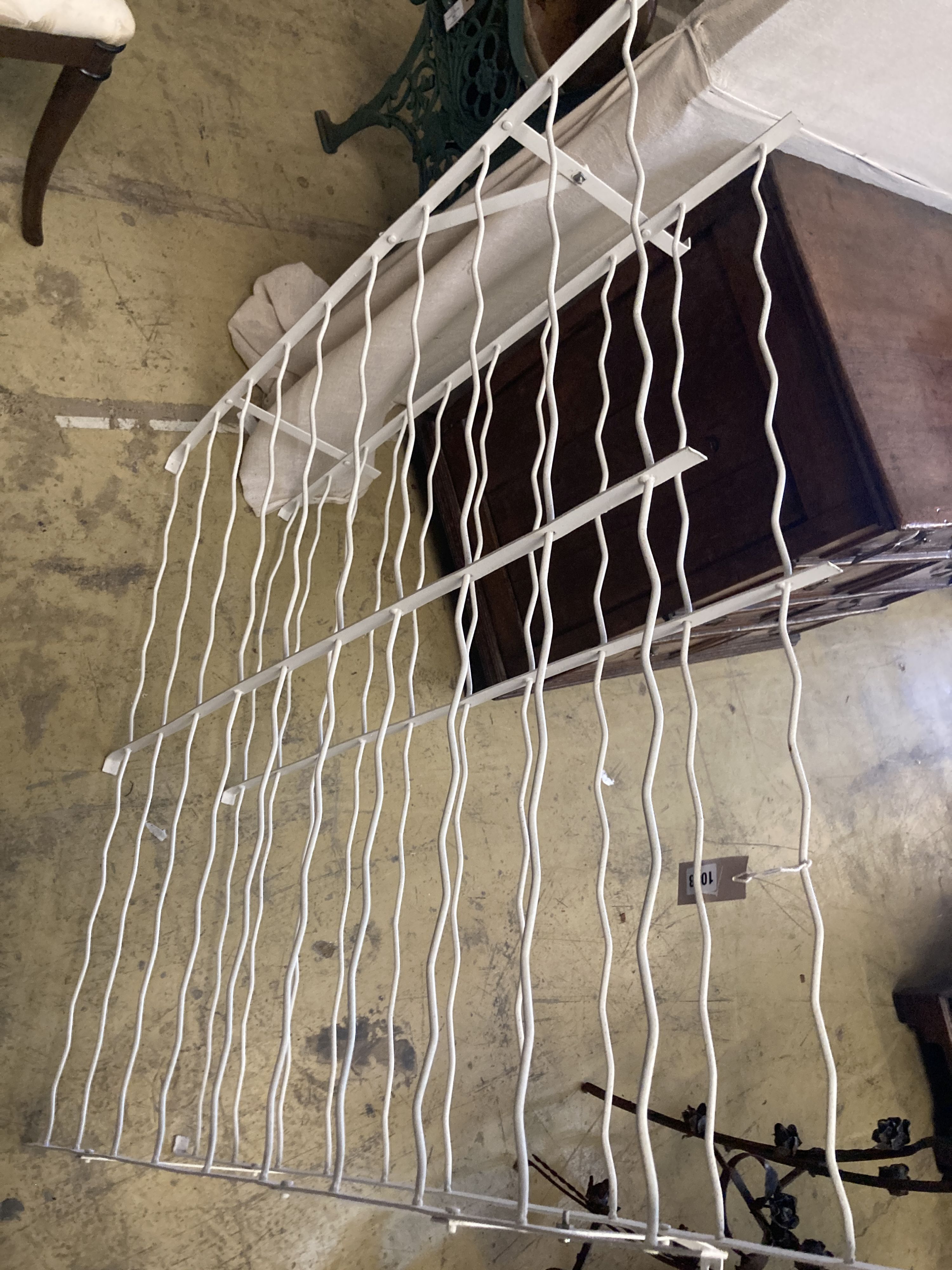 A painted wrought iron wine rack, width 98cm, depth 19cm, height 104cm